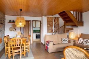 a kitchen and living room with a table and chairs at Chalet de montaña con vistas in Prullans