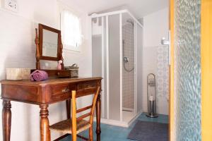 a bathroom with a wooden desk and a mirror at La Vecchia Torre in Porto Valtravaglia +22 photos