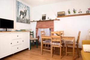 a dining room with a table and chairs and a tv at La Vecchia Torre in Porto Valtravaglia
