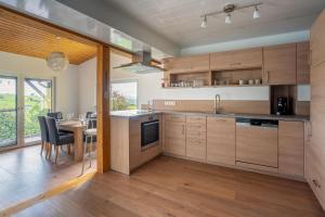 a kitchen with wooden cabinets and a table with chairs at Ferienwohnung Agnes in Rheinfelden