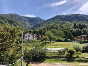 a view of a field with mountains in the background at La Vecchia Torre in Porto Valtravaglia
