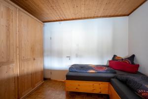 a bedroom with a bed and a wooden cabinet at Ferienwohnung Agnes in Rheinfelden