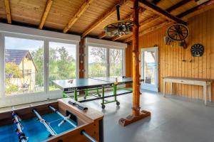 a ping pong table in a room with wooden walls at Ferienwohnung Agnes in Rheinfelden