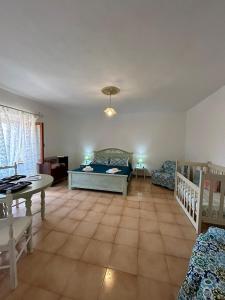 a living room with two beds and a table at Casa Sonia in Osilo