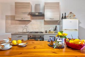 a kitchen with a wooden table with fruit on it at Casa Sonia in Osilo +12 photos