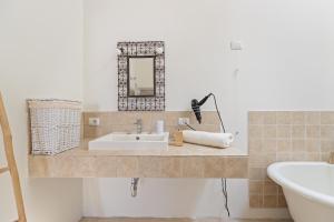 a bathroom with a sink and a mirror at I Tre Nuraghi in Tresnuraghes +27 photos