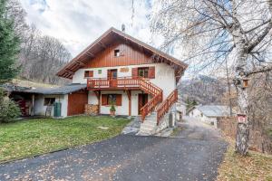 a house with a staircase in front of it at Chalet les églantiers in Valloire