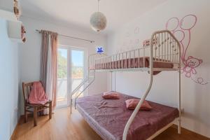 a bedroom with a bunk bed and a window at Casa d' Ana in Sesimbra +27 photos