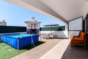 a pool on the roof of a house at Casa d' Ana in Sesimbra