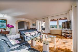 a living room with a couch and a table at Algueret in Portopetro