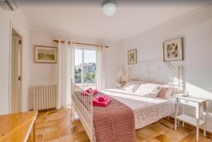 a bedroom with a large bed and a window at Algueret in Portopetro +25 photos