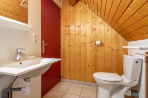 a bathroom with a white toilet and a sink at Chartrousin in Saint-Hilaire +25 photos