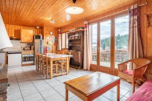 a kitchen with a table and chairs in a room at Chartrousin in Saint-Hilaire