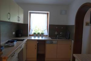 a kitchen with a sink and a window at Ferienwohnung Zugspitze in Grainau