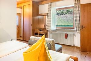 a hotel room with two beds and a window at Cesa Soramurat Appartamento 4 in Canazei
