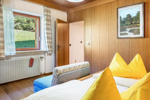 a bedroom with a large bed and a window at Cesa Soramurat Appartamento 4 in Canazei