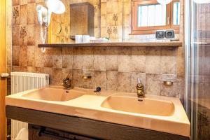 a bathroom with a sink and a shower at Cesa Soramurat Appartamento 4 in Canazei +14 photos