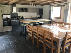 a kitchen with a large wooden table and chairs at Chalet L'envers in Champagny-en-Vanoise