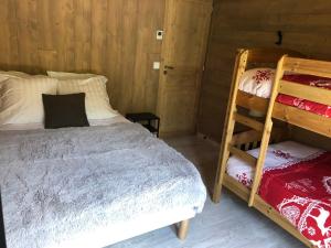 a bedroom with two bunk beds and a ladder at Chalet L'envers in Champagny-en-Vanoise