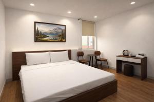 a bedroom with a bed and a desk and a window at Dreamora Centre Hotel in Hanoi