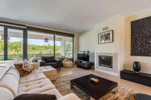 a living room with a couch and a fireplace at Casa Praia do Meco in Sesimbra