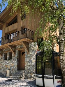 a house with a tree in front of it at Chalet L'envers in Champagny-en-Vanoise