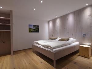 a bedroom with a bed and a wooden wall at Ferienwohnung Am Lennepark in Schmallenberg