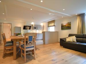 a living room and kitchen with a table and a couch at Ferienwohnung Am Lennepark in Schmallenberg
