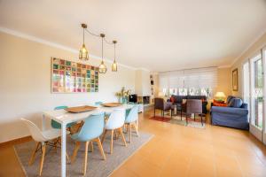 a dining room and living room with a table and chairs at Finca Es Pi in Llucmajor +20 photos