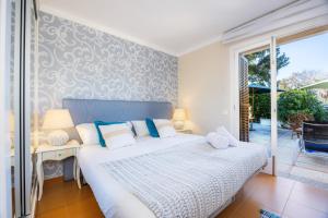 a bedroom with a bed and a sliding glass door at Finca Es Pi in Llucmajor