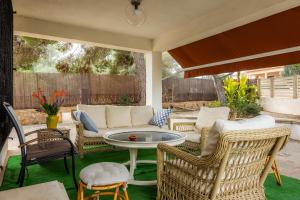 a patio with wicker furniture and a table and chairs at Finca Es Pi in Llucmajor
