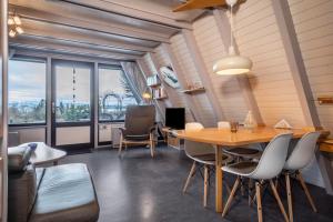 a room with a table and chairs and a large window at Seeblick in Immenstaad am Bodensee