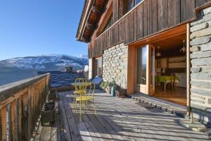a wooden deck with a table and chairs on it at Chalet Paisible in Bourg-Saint-Maurice +12 photos