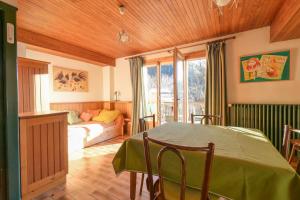 a living room with a table and a bed in a room at Chalet Paisible in Bourg-Saint-Maurice