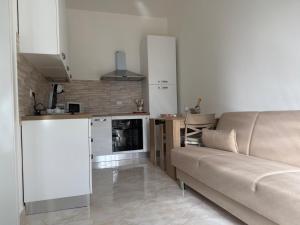 a living room with a couch and a kitchen at Domus Teresa in Capoterra