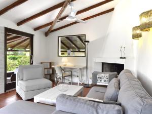 a living room with a couch and chairs and a table at Villa Bua in Costa Rei