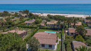 an aerial view of a house and the beach at Villa Bua in Costa Rei