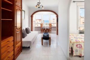 a living room with a white couch and a table at Estudios 79 in Torrox +58 photos