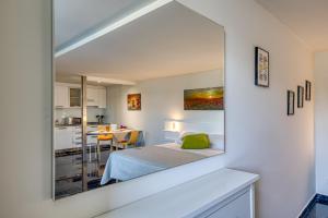 a bedroom with a mirror on the wall at Residence Margherita in Ugento