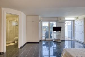 a room with a bathroom with a toilet and a television at Residence Margherita in Ugento +89 photos