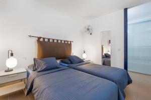 two beds sitting next to each other in a bedroom at Carmina House in Costa Calma