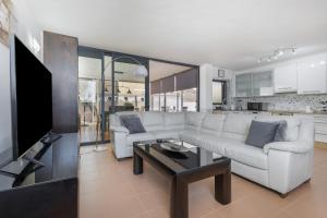 a living room with a white couch and a table at Carmina House in Costa Calma +21 photos
