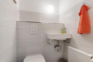 a white bathroom with a toilet and a sink at Urlaub Im Häusle in Loßburg +15 photos