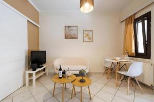 a living room with a tv and a table and chairs at Breathing Apartments in Virós