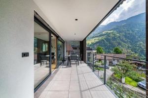 a balcony with a view of the mountains at Aktiv Lodge Meran - Terrace Two in San Martino