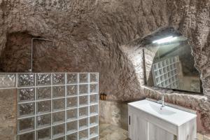 a bathroom with a sink and a stone wall at Casa Efrén in Garafía +15 photos