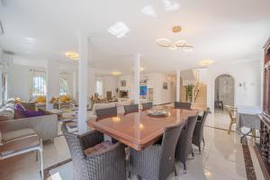 a dining room and living room with a table and chairs at Marbella Villa 16 Persons -Pool in Marbella