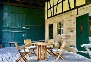 a wooden table and chairs on a patio at Villa Buselmeier in Neuried