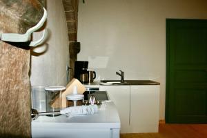 a small kitchen with a sink and a counter at Villa Buselmeier in Neuried +28 photos