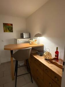 a kitchen with a desk with a microwave and a chair at Ferienwohnung Silbergarten in Clausthal-Zellerfeld